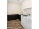 Laundry room with dark cabinets and granite countertop at 18280 W Sells Dr, Goodyear, AZ 85395