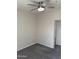 An empty bedroom with gray carpet features a window and ceiling fan with light at 280 S Evergreen Rd # 1301, Tempe, AZ 85288