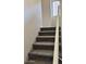 Carpeted stairway with a white handrail providing safe access to the upper floor at 280 S Evergreen Rd # 1301, Tempe, AZ 85288