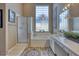 Elegant bathroom with double sinks, a soaking tub and a walk-in shower at 3212 E Desert Cove Ave, Phoenix, AZ 85028