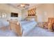 Comfortable bedroom with a sleigh bed and a large TV at 3212 E Desert Cove Ave, Phoenix, AZ 85028