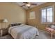 Cozy bedroom with a queen-size bed and a ceiling fan at 3212 E Desert Cove Ave, Phoenix, AZ 85028