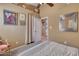 Charming bedroom with a queen-size bed and access to another room at 3212 E Desert Cove Ave, Phoenix, AZ 85028