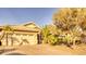 House with two-car garage and mature desert landscaping at 3212 E Desert Cove Ave, Phoenix, AZ 85028