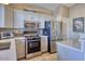 Modern kitchen with stainless steel appliances and white cabinets at 3212 E Desert Cove Ave, Phoenix, AZ 85028