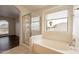 Bathroom with shower, bathtub, and window view at 3555 S Payton St, Mesa, AZ 85212