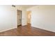 Light and airy bedroom with wood-look floors and mirrored closet at 3555 S Payton St, Mesa, AZ 85212