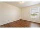 Well-lit bedroom with wood-look floors and window blinds at 3555 S Payton St, Mesa, AZ 85212