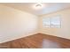 Bright bedroom featuring wood-look floors and window blinds at 3555 S Payton St, Mesa, AZ 85212