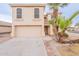 Two-story house with a large garage and mature palm trees in the front yard at 3555 S Payton St, Mesa, AZ 85212