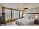 Bright bedroom with neutral tones, large windows with sheer curtains, and a plush carpet at 5322 W Coles Rd, Laveen, AZ 85339