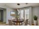 Cozy dining area with contemporary light fixture and a sliding door that offers access to outdoor space at 5322 W Coles Rd, Laveen, AZ 85339
