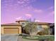 Charming two-story home features a two-car garage and well-manicured front yard with beautiful flowering shrubbery at 5322 W Coles Rd, Laveen, AZ 85339