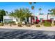 Single story home with red door, landscaping, and a two car garage at 6012 E Redfield Rd, Scottsdale, AZ 85254