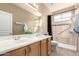 Bathroom with double sinks, shower, and grab bars at 8141 E Apache Plumb Dr, Gold Canyon, AZ 85118