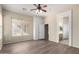 Bedroom with wood-look flooring, large window and access to bathroom at 8141 E Apache Plumb Dr, Gold Canyon, AZ 85118