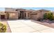 Single-story home with a large driveway and desert landscaping at 8141 E Apache Plumb Dr, Gold Canyon, AZ 85118