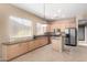 Kitchen with light wood cabinets, stainless steel appliances, and an island at 8141 E Apache Plumb Dr, Gold Canyon, AZ 85118