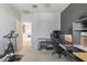 Home office with built-in desk and exercise bike at 8184 N 22Nd Dr, Phoenix, AZ 85021