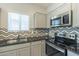 Modern kitchen with stainless steel appliances and granite countertops at 8184 N 22Nd Dr, Phoenix, AZ 85021