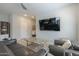 Living room features grey couches and a large TV at 8184 N 22Nd Dr, Phoenix, AZ 85021