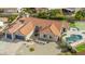 Expansive aerial view featuring a pool, a basketball court, desert landscaping, and an attached two-car garage at 905 E Knight Ln, Tempe, AZ 85284