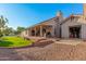 Spacious backyard with covered patio, lush lawn, and access to the garage, perfect for outdoor living at 905 E Knight Ln, Tempe, AZ 85284