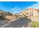 Backyard patio with stucco walls, steps to tennis court and desert landscaping at 905 E Knight Ln, Tempe, AZ 85284