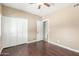 Bedroom with hardwood floors, closet with folding doors, and an open door to the bathroom at 905 E Knight Ln, Tempe, AZ 85284