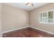 Bedroom featuring hardwood floors, a ceiling fan, neutral color palette, and plantation shutters at 905 E Knight Ln, Tempe, AZ 85284