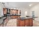 Spacious kitchen featuring stainless steel appliances, black countertops, and lots of cabinet space at 905 E Knight Ln, Tempe, AZ 85284