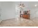 Open-concept kitchen with a bar and wood cabinetry, with views into the dining and living spaces at 905 E Knight Ln, Tempe, AZ 85284