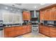 Modern kitchen featuring stainless steel appliances, black countertops, and unique backsplash at 905 E Knight Ln, Tempe, AZ 85284
