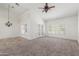 Spacious living room featuring a ceiling fan, French doors, and plantation shutters at 905 E Knight Ln, Tempe, AZ 85284