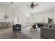 Bright staged living room featuring French doors, a ceiling fan, neutral decor, and lots of natural light at 905 E Knight Ln, Tempe, AZ 85284