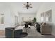 Staged living room featuring French doors, neutral decor, and lots of natural light at 905 E Knight Ln, Tempe, AZ 85284