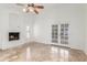 Living room with a stone fireplace, French doors leading to the patio, and travertine floors at 905 E Knight Ln, Tempe, AZ 85284