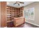 Office with hardwood floors, wooden built-in shelves, a desk, and plantation shutters at 905 E Knight Ln, Tempe, AZ 85284