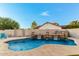 Backyard pool with cascading water feature, desert landscaping and blue accent chair at 905 E Knight Ln, Tempe, AZ 85284