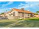 Full tennis court next to a two-story house with a tile roof and an outdoor dining area at 905 E Knight Ln, Tempe, AZ 85284