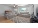 Living area with gray sofas, a TV, and a large window at 1054 E 2Nd Pl, Mesa, AZ 85203