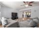 Open living room with gray sofas, a large TV, and view into dining area at 1054 E 2Nd Pl, Mesa, AZ 85203