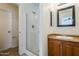 Clean bathroom with wood vanity, granite countertop, and shower stall at 11706 W Shaw Butte Dr, El Mirage, AZ 85335