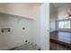 Convenient laundry room with built-in shelving and hookups at 11706 W Shaw Butte Dr, El Mirage, AZ 85335