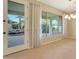 Bright dining area with patio door leading to a backyard water feature at 13520 W Junipero Dr, Sun City West, AZ 85375