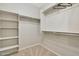 Spacious walk-in closet with hanging rods and shelves for storage at 13520 W Junipero Dr, Sun City West, AZ 85375