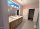 Spacious bathroom features a double vanity, a separate walk-in closet, and ample lighting at 15900 W Autumn Sage Dr, Surprise, AZ 85374