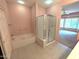 Modern bathroom featuring a soaking tub and a glass-enclosed shower, seamlessly connecting to the Primary bedroom at 15900 W Autumn Sage Dr, Surprise, AZ 85374