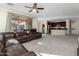 Open living room with L-shaped sectional sofa and kitchen view at 1850 S Martingale Rd, Gilbert, AZ 85295