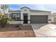 One-story home with a gray garage door and desert landscaping at 18793 W Farmer Rd, Buckeye, AZ 85326
